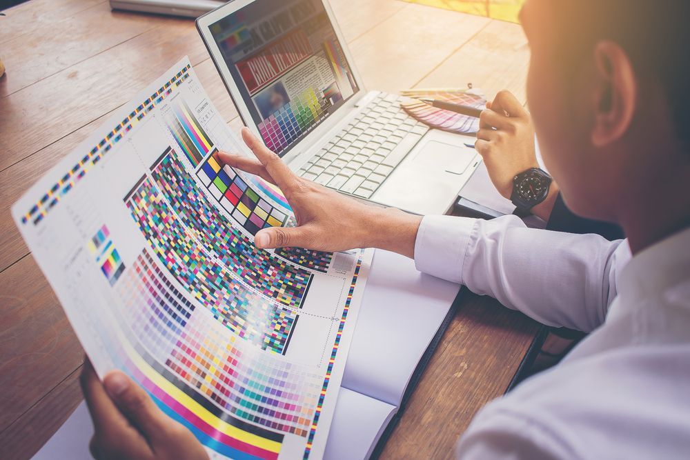 Man Working Graphic With Color Chart — Graphic Designer In Wollongong, QLD