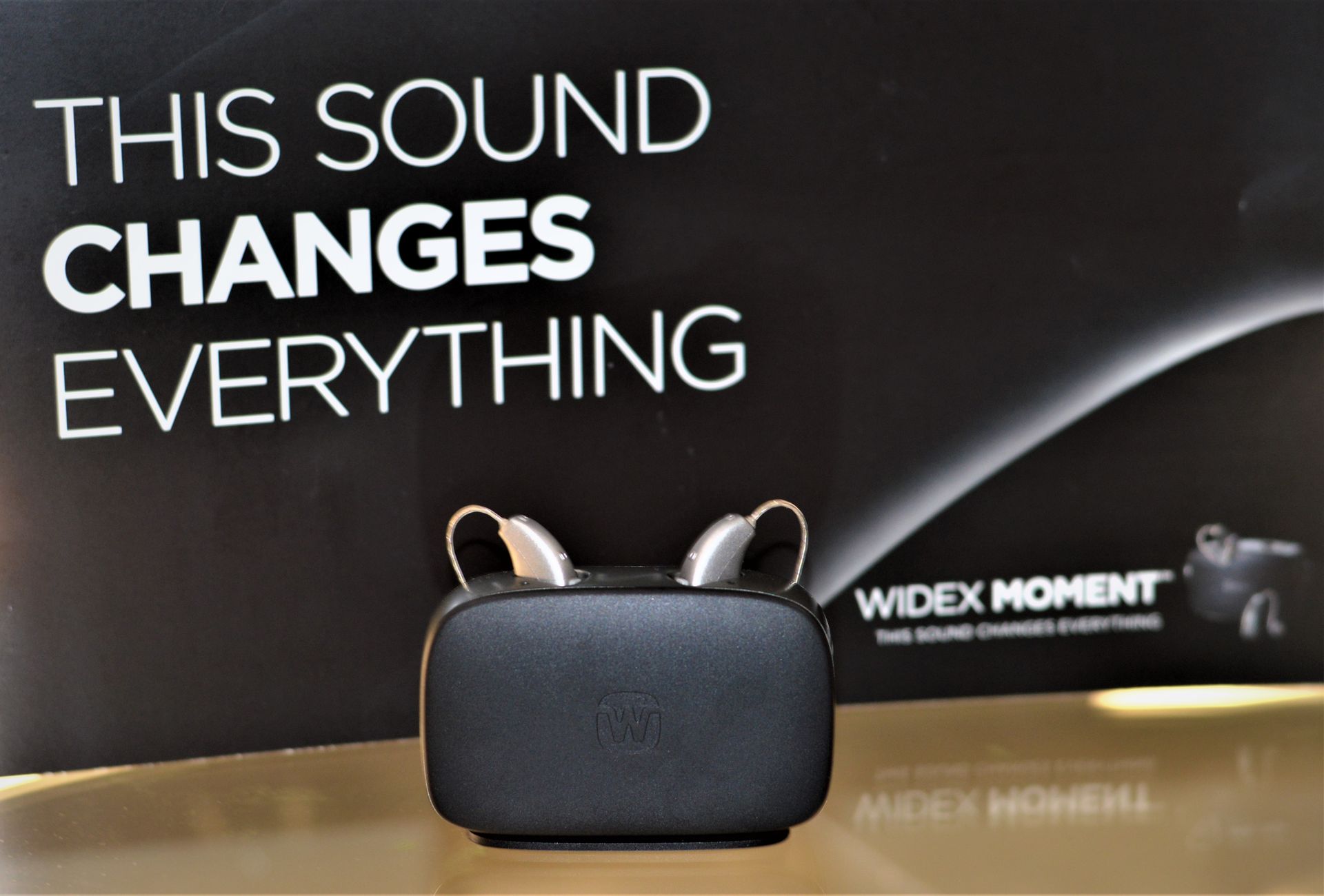 Hearing aids in a charging case, with the tagline 