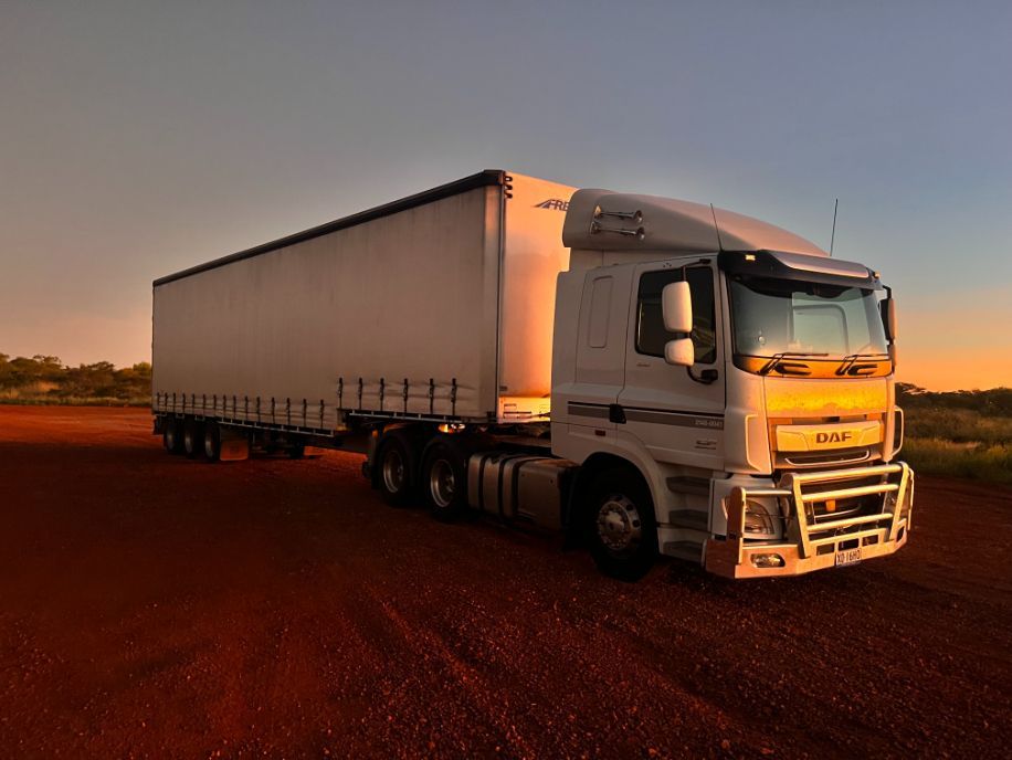 A White Semi Truck is Parked on a Dirt Road — Goulburn Transport In Goulburn, NSW