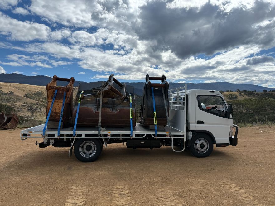 A White Truck is Sitting on Top of a Dirt Field — Goulburn Transport In Goulburn, NSW