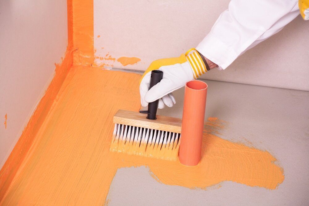 A Person Is Painting A Floor With A Brush — Heness Painting In Park Avenue, QLD