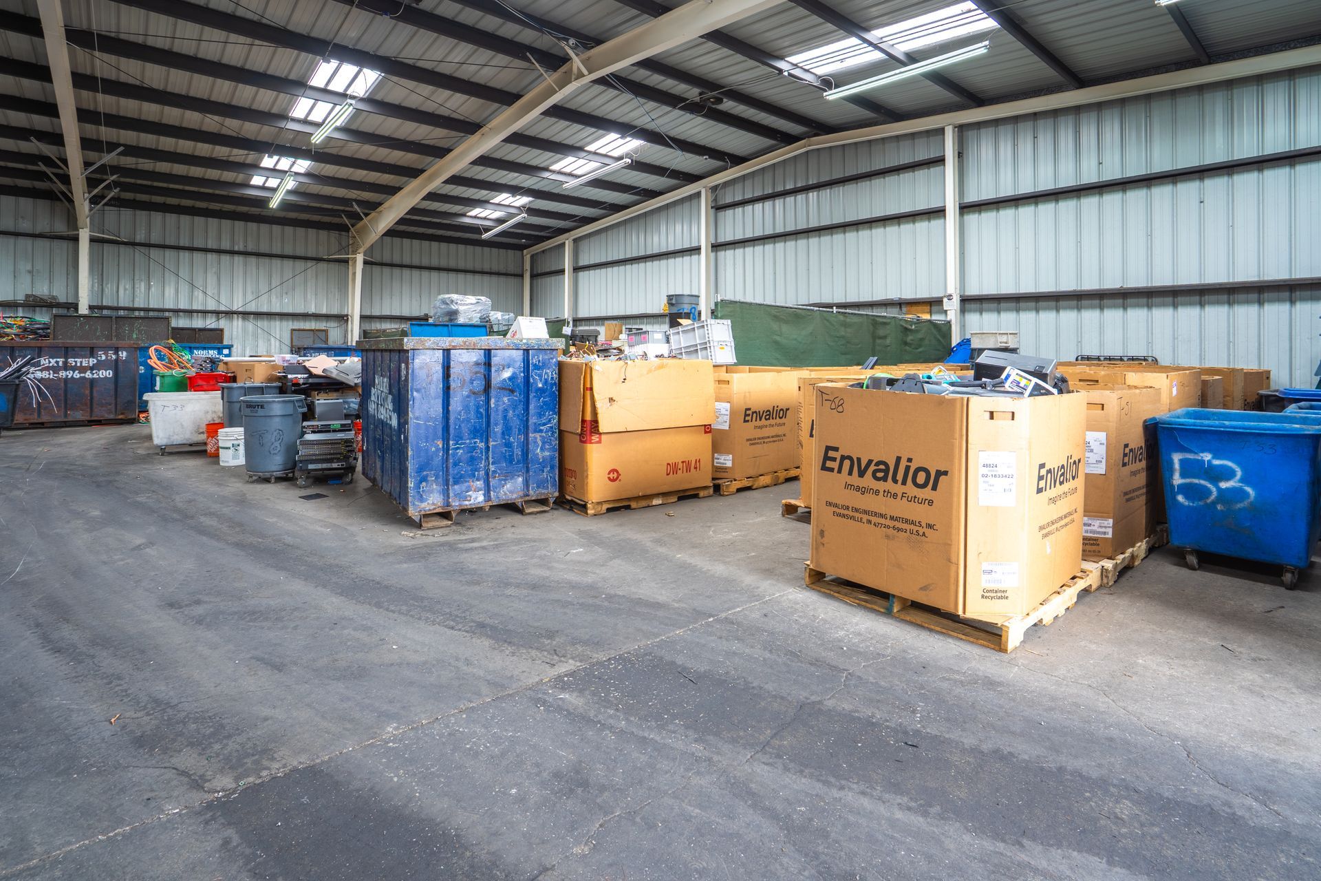 A large warehouse filled with lots of boxes and pallets.