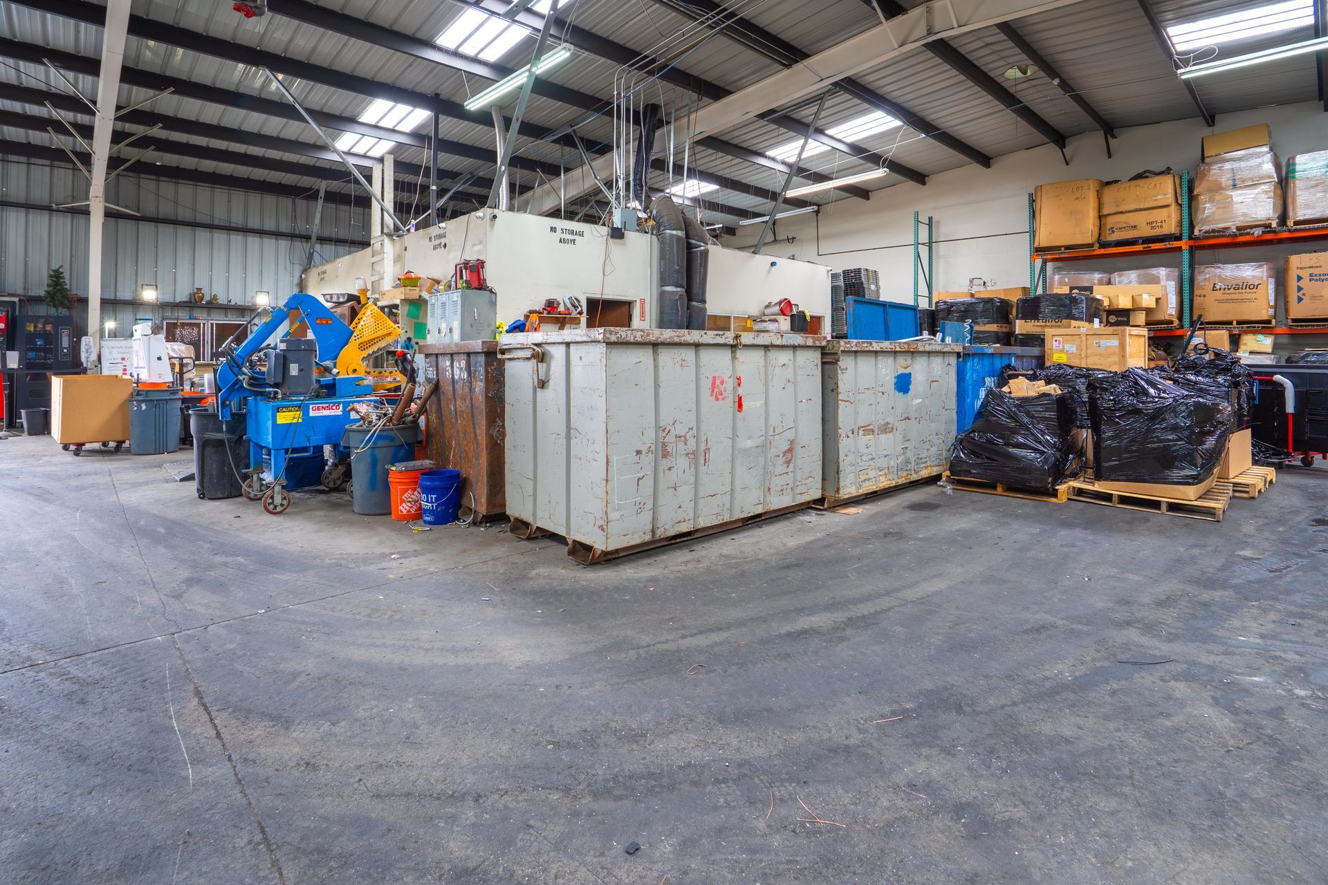 A large warehouse filled with lots of boxes and machinery.