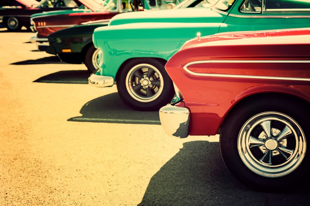 Row of Colorful Classic Cars at an Outdoor Car Show — Bundaberg Radiator Service in Bundaberg East, QLD
