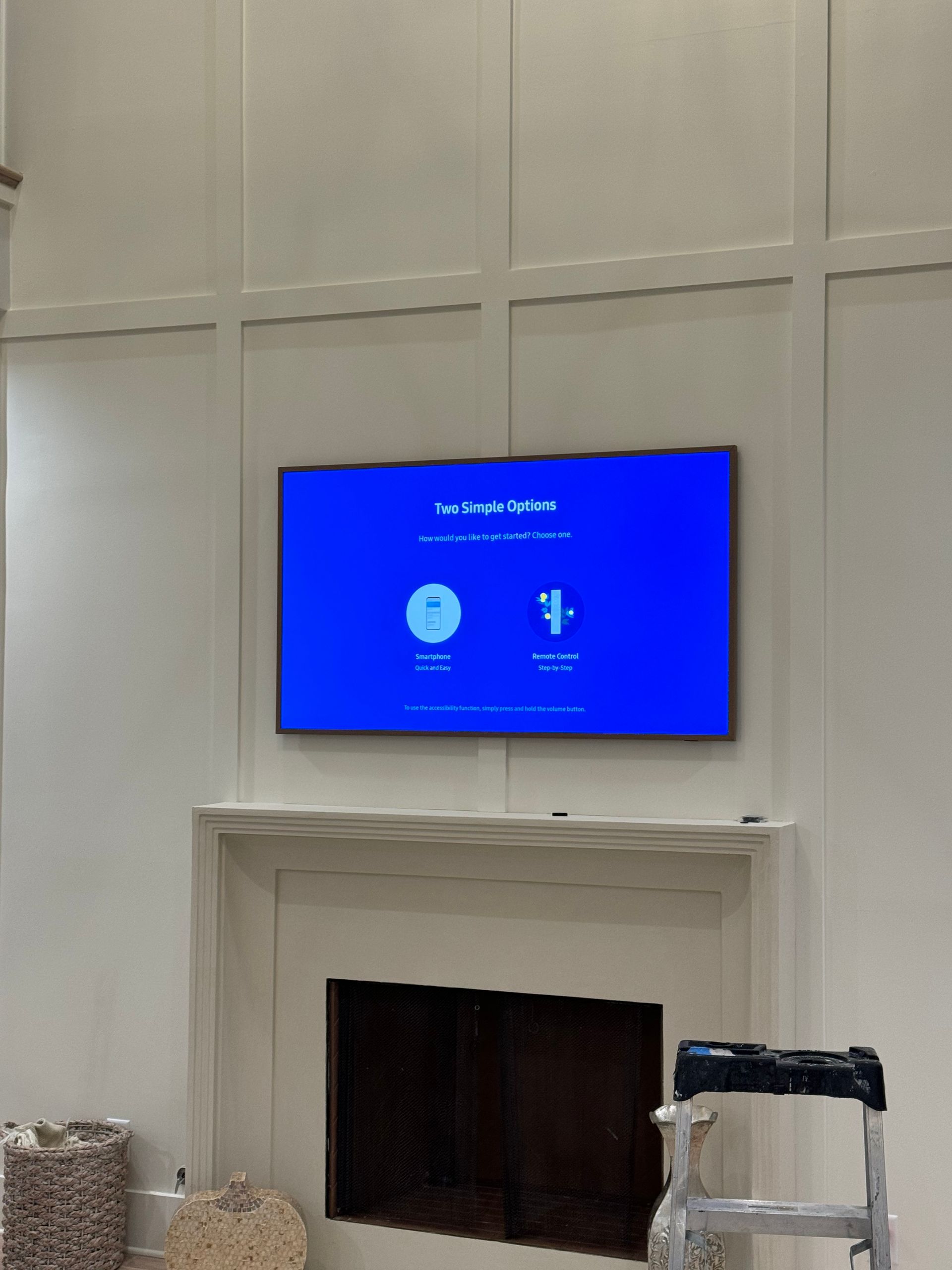 A flat screen tv is mounted above a fireplace in a living room.