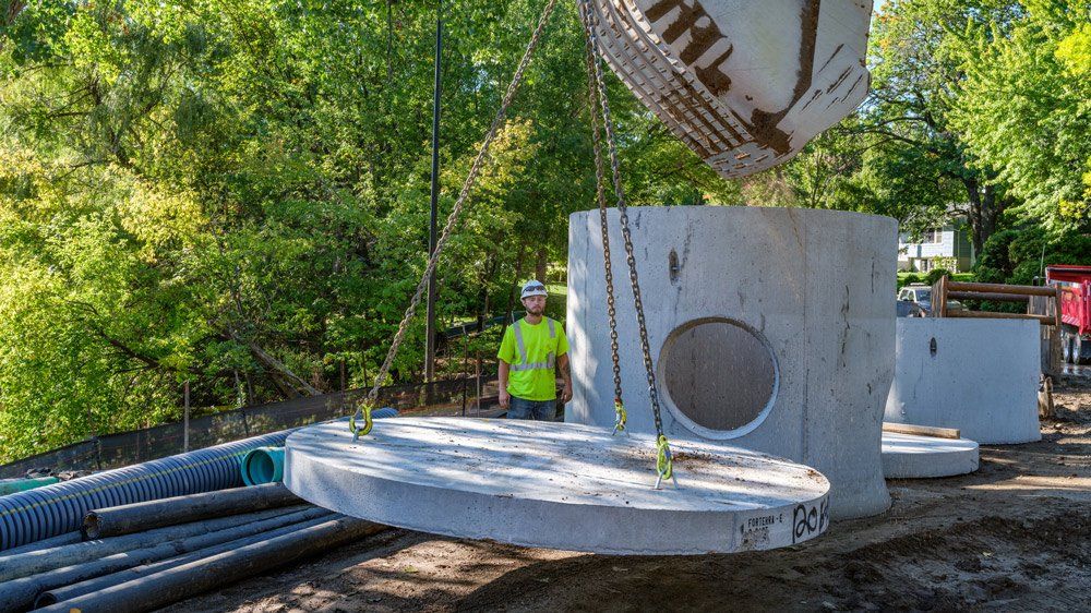 Man Installing Sewer — Chaska, MN — Kusske Construction Company
