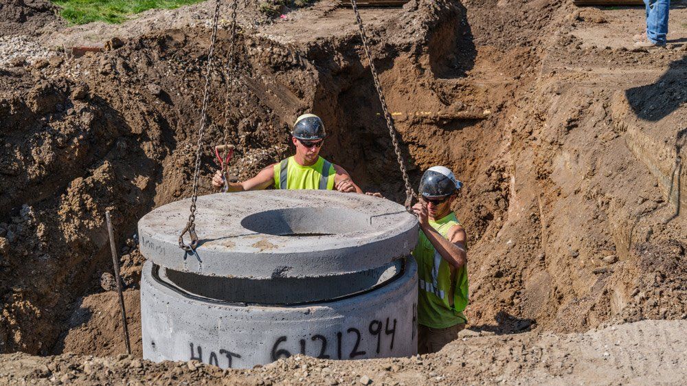 Men Working to New Sewer Underground — Chaska, MN — Kusske Construction Company