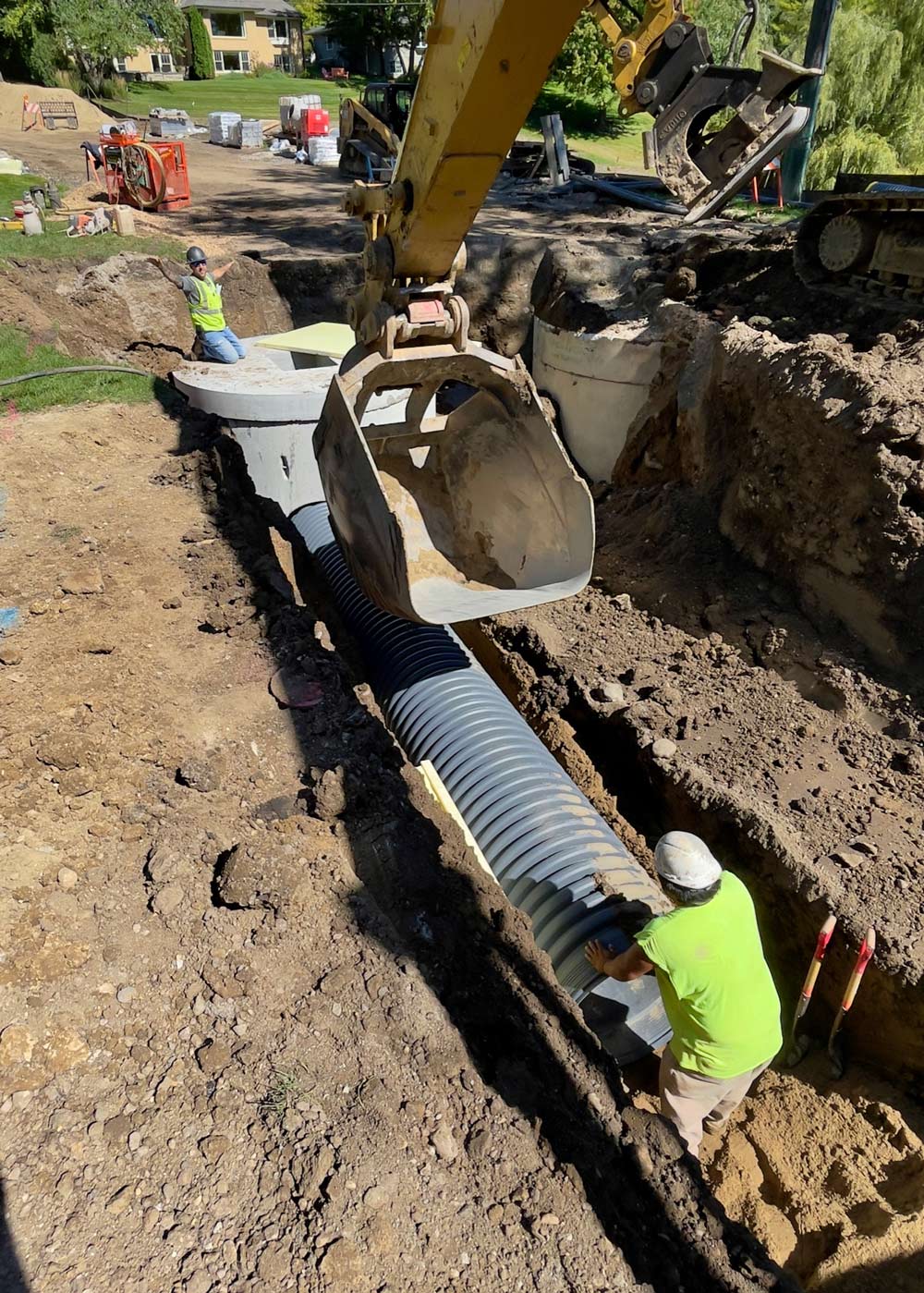 Men Installing Sewer Underground — Chaska, MN — Kusske Construction Company