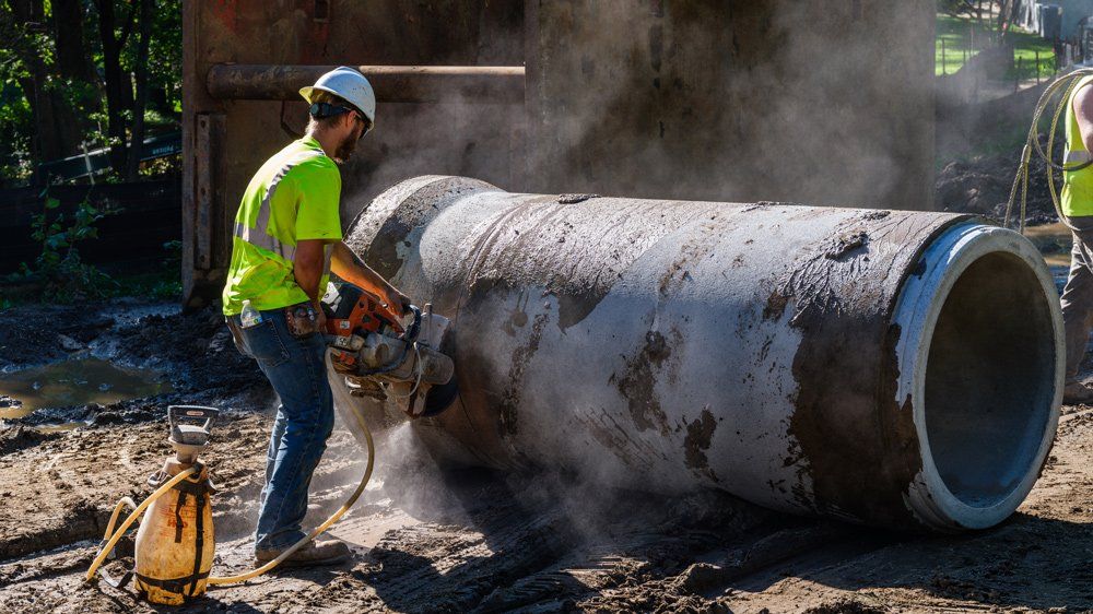 Worker Cleaning Sewer — Chaska, MN — Kusske Construction Company
