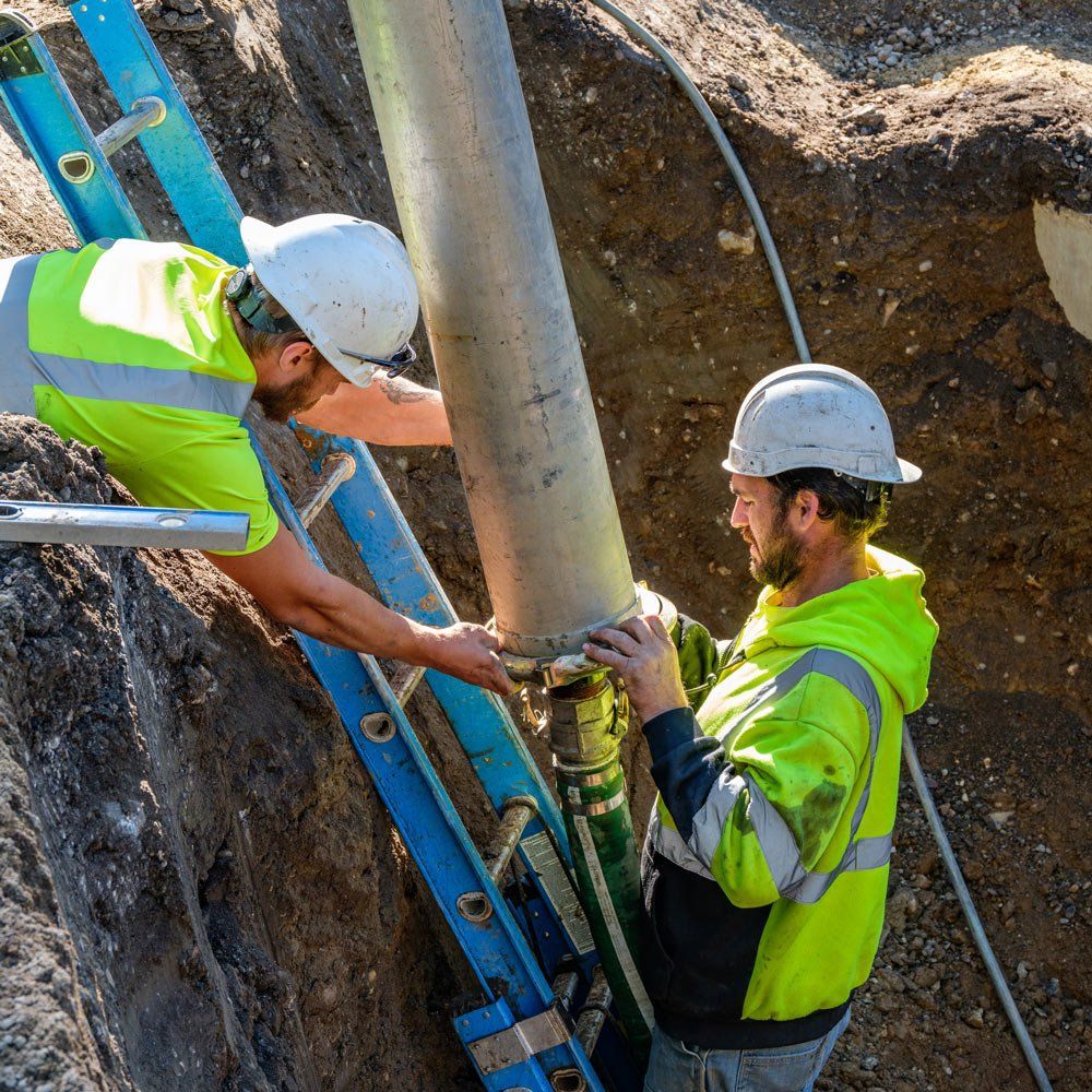 Men Installing Storm Metal Sewer — Chaska, MN — Kusske Construction Company