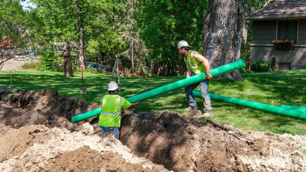 Two Men Putting Pipes On the Underground — Chaska, MN — Kusske Construction Company