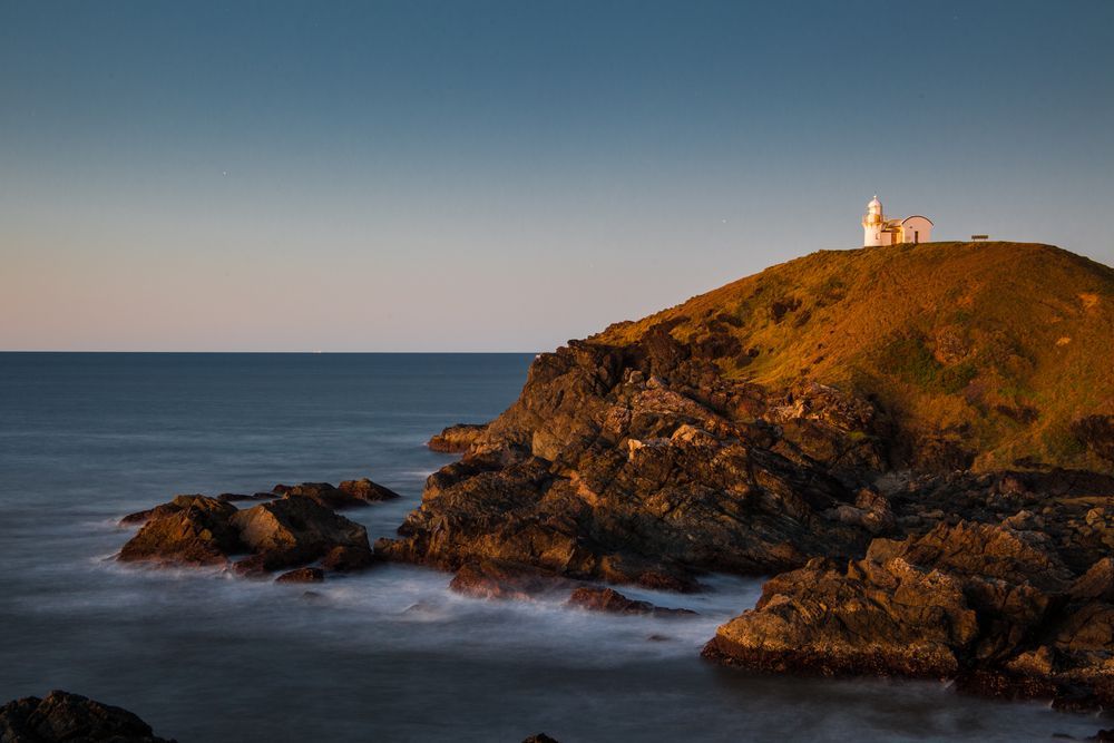 A Lighthouse on Top of a Rocky Hill Overlooking the Ocean — Cape Byron Plumbing in Ocean Shores, NSW