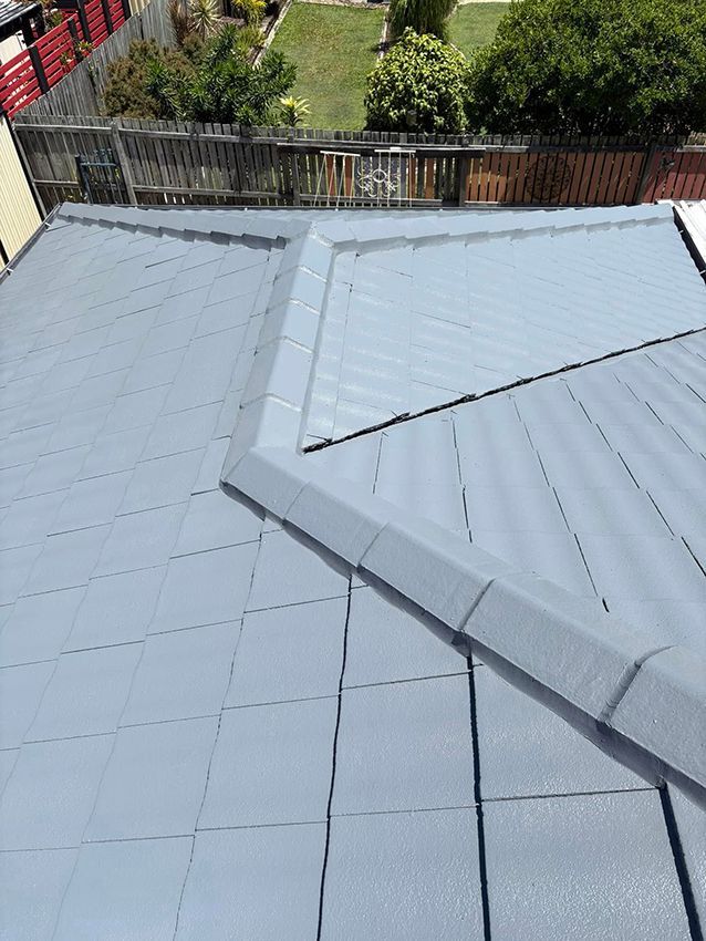 A Close Up of a Roof with a Fence in the Background — Boss Roof Tiling and Restoration in Caboolture, QLD