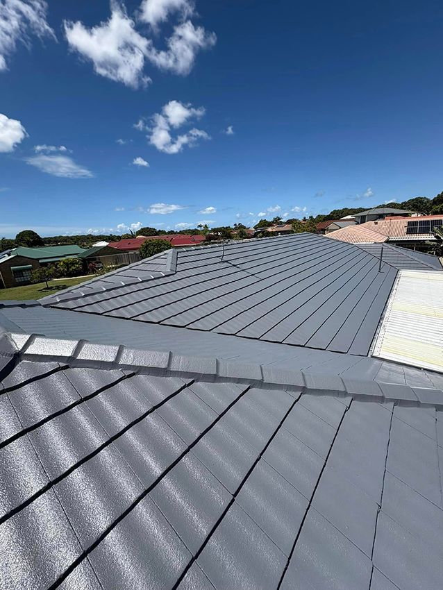 A Close Up of a Roof with a Blue Sky in the Background — Boss Roof Tiling and Restoration in Caboolture, QLD