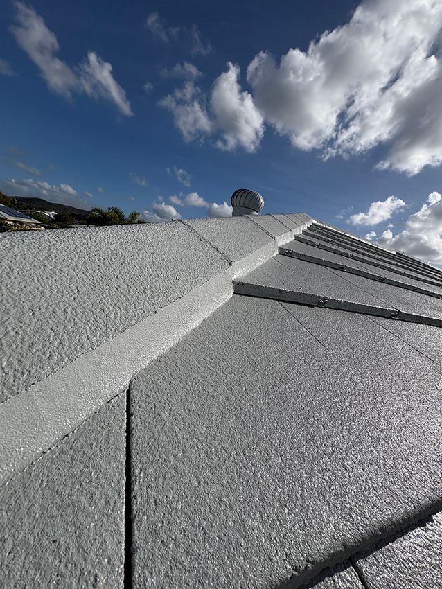 A Close Up of a Roof with a Blue Sky and Clouds in the Background — Boss Roof Tiling and Restoration in Caboolture, QLD