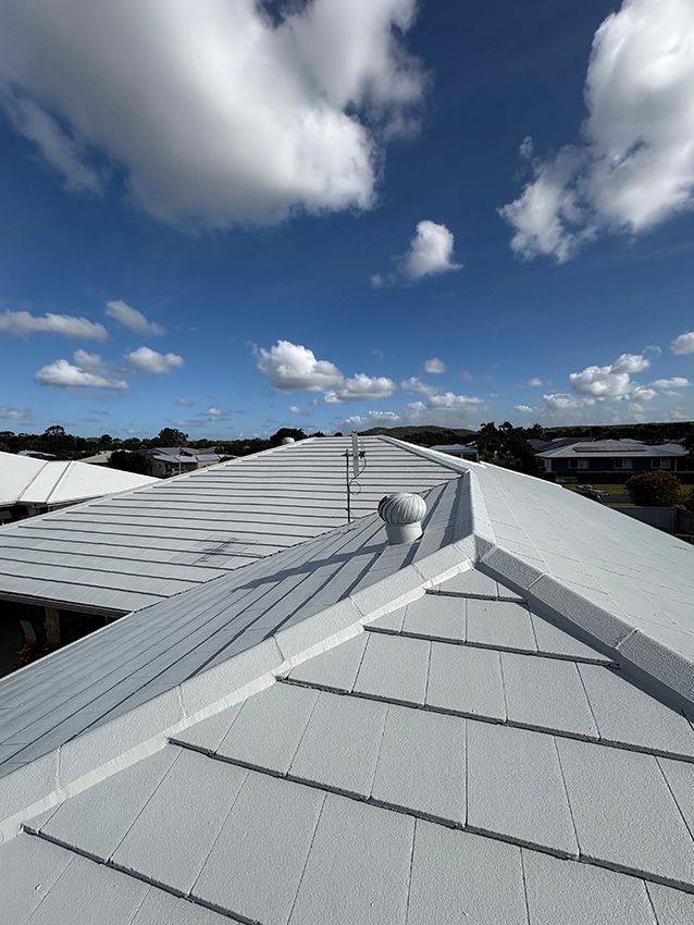 A White Roof with a Blue Sky in the Background — Boss Roof Tiling and Restoration in Caboolture, QLD