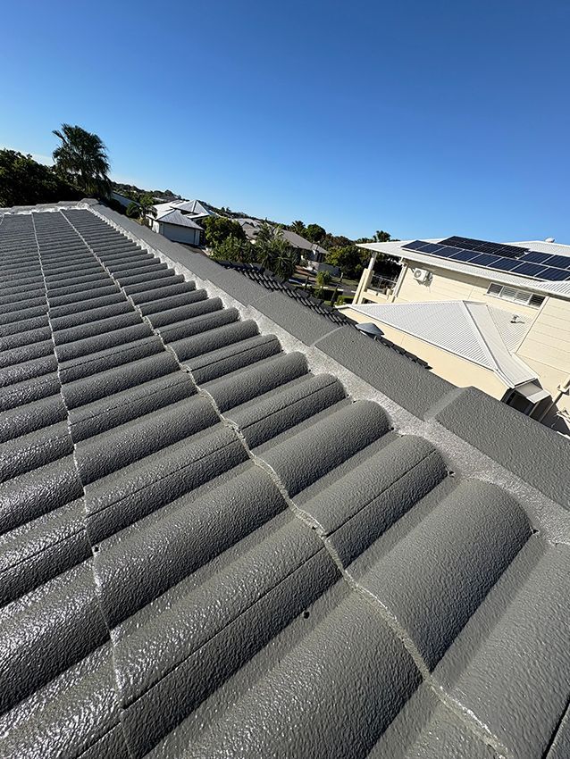 A Roof with a Lot of Tiles and Solar Panels on It — Boss Roof Tiling and Restoration in Caboolture, QLD