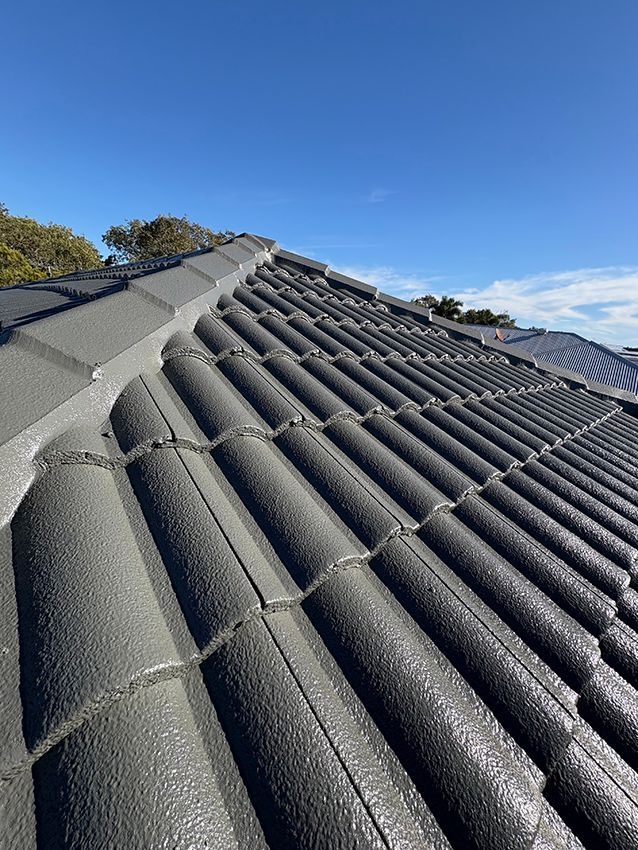 A Close Up of a Roof with a Blue Sky in the Background — Boss Roof Tiling and Restoration in Caboolture, QLD