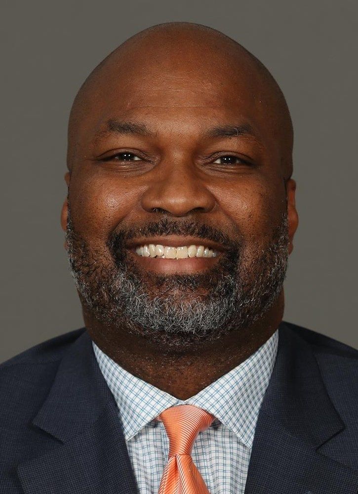 A man in a suit and tie is smiling for the camera.