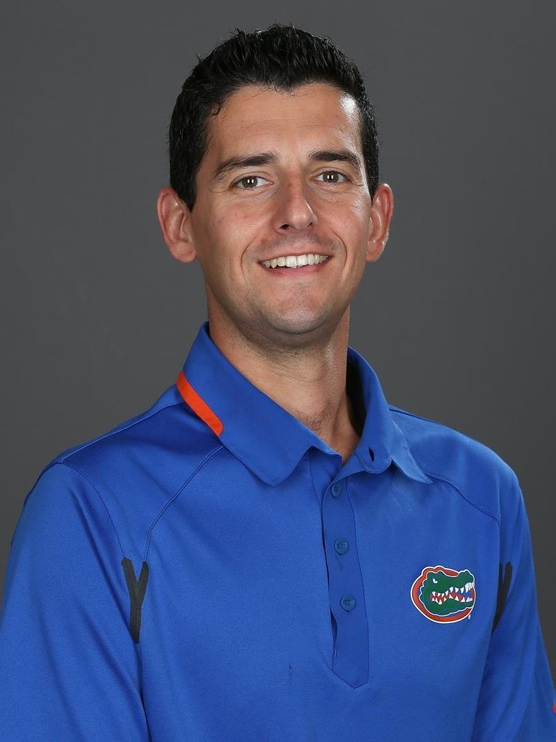 A man wearing a blue shirt with a gator on it