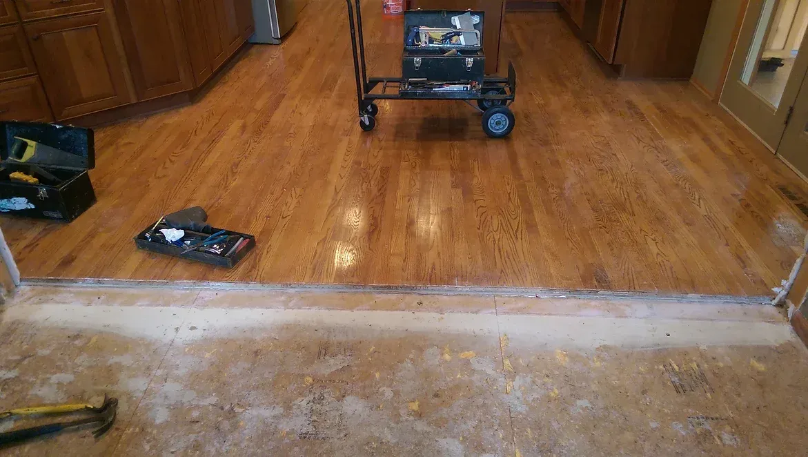 A wooden floor with a cart and hammers on it.