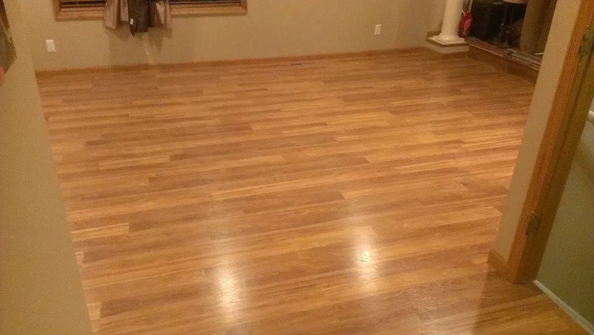 A living room with hardwood floors and a fireplace.
