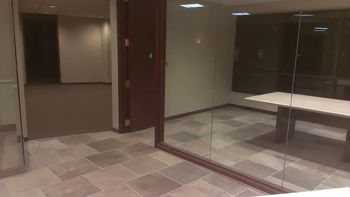 An empty room with a table and a mirror