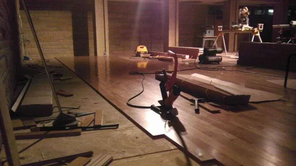 A wooden floor is being installed.