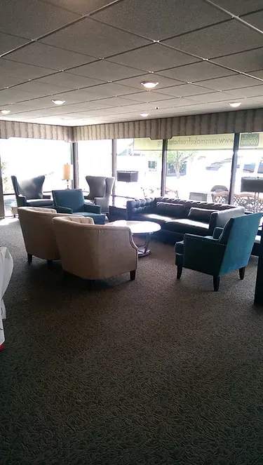 A living room filled with furniture and a lot of windows.