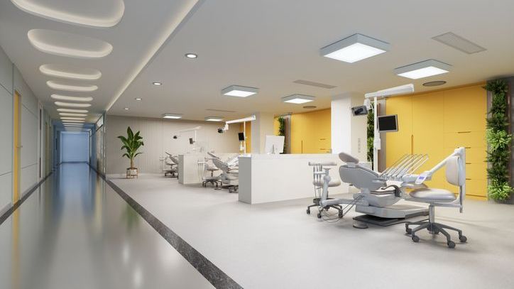 A dental office with a long hallway and a row of dental chairs.