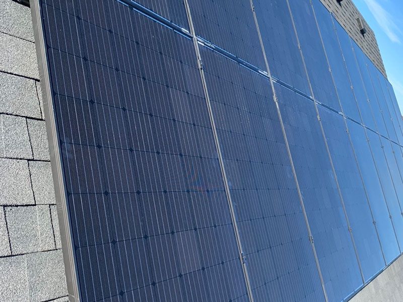 A row of solar panels on the side of a building.