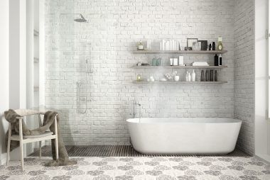 A bathroom with a bathtub , chair , shelves and a shower.