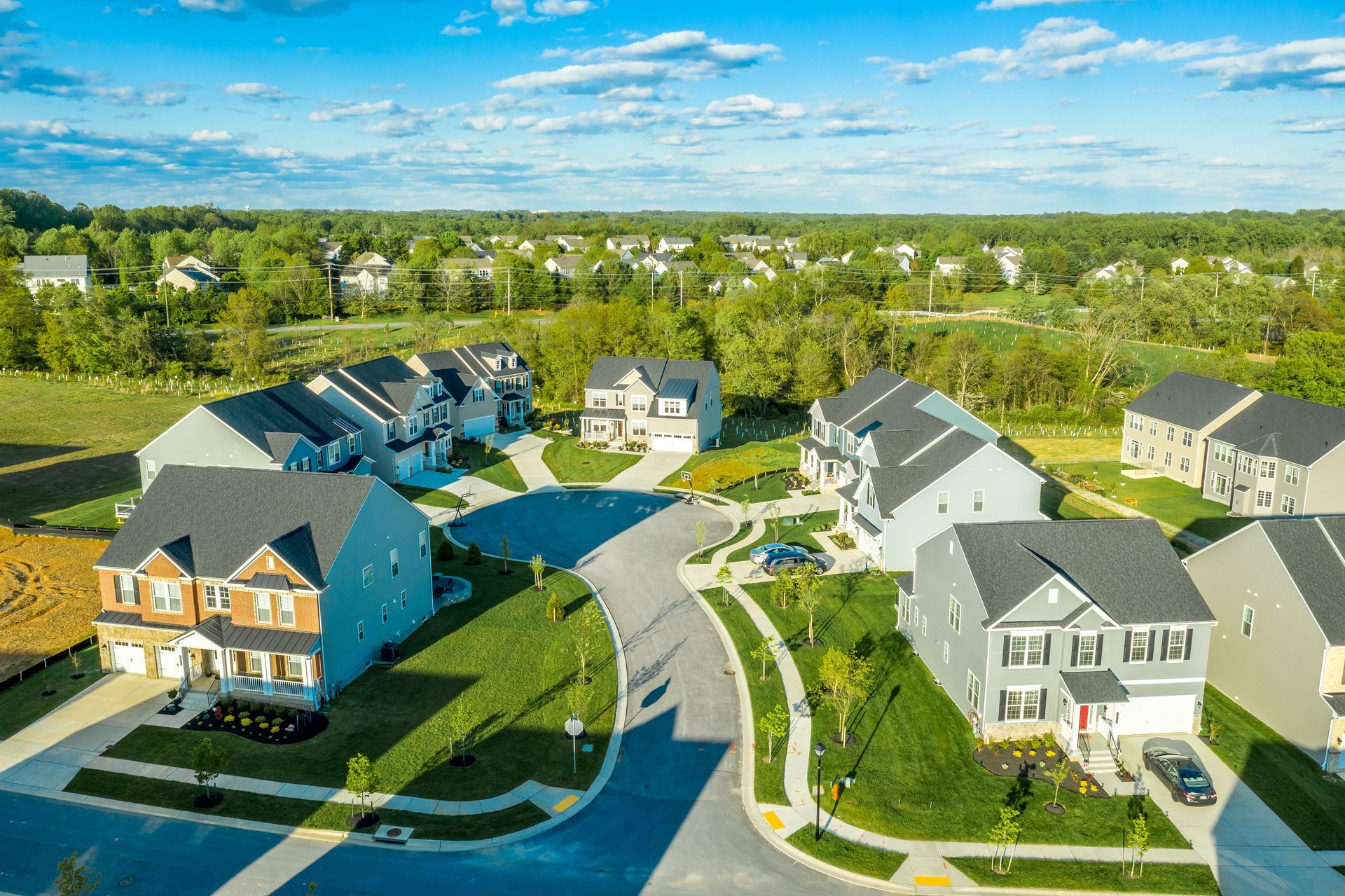 An aerial view of a residential neighborhood with lots of houses and trees.