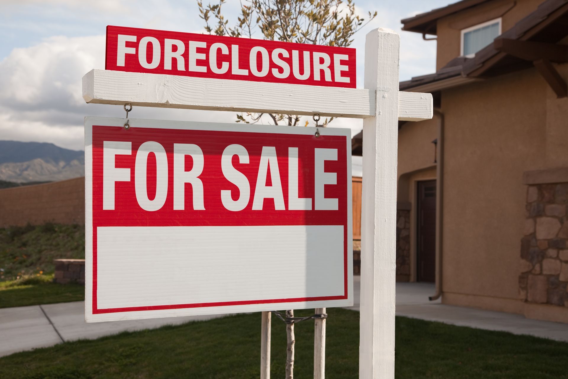 A foreclosure sign in front of a house