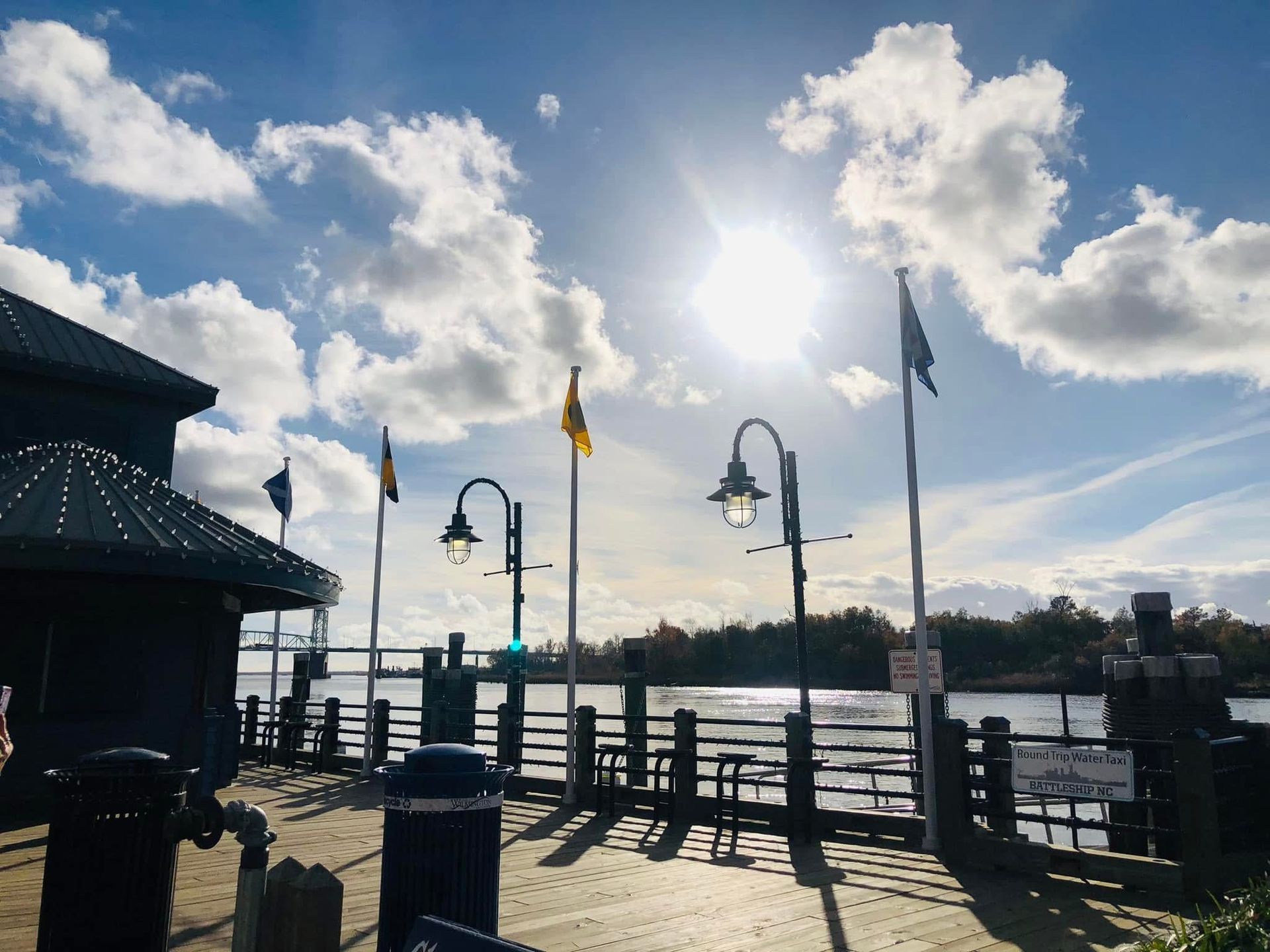 Cape Lookout Lighthouse in North Carolina, black and white diamond pattern, on a sandy island with ocean and marsh in the background.