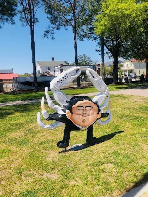 Bridge over water at night, lit by streetlights; cars driving on the bridge.