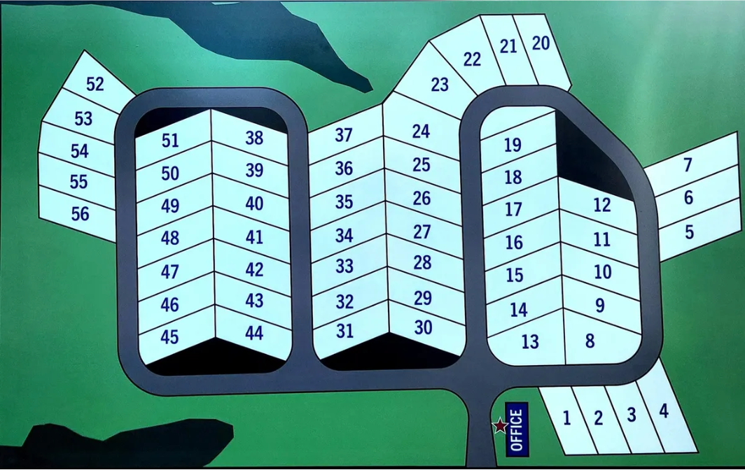 Map of a campground showing numbered campsites with roads and green background.