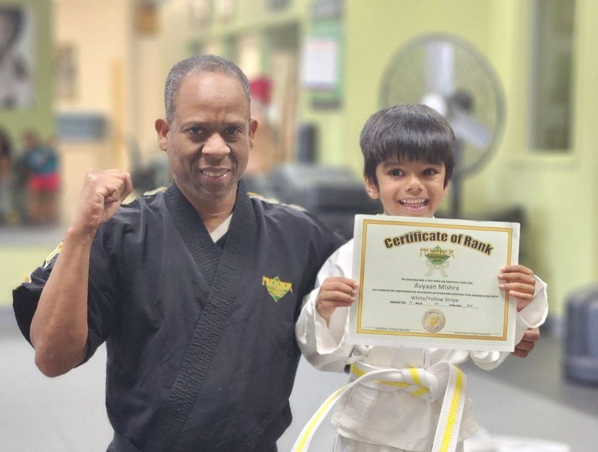 A man and a woman are practicing karate in a gym.