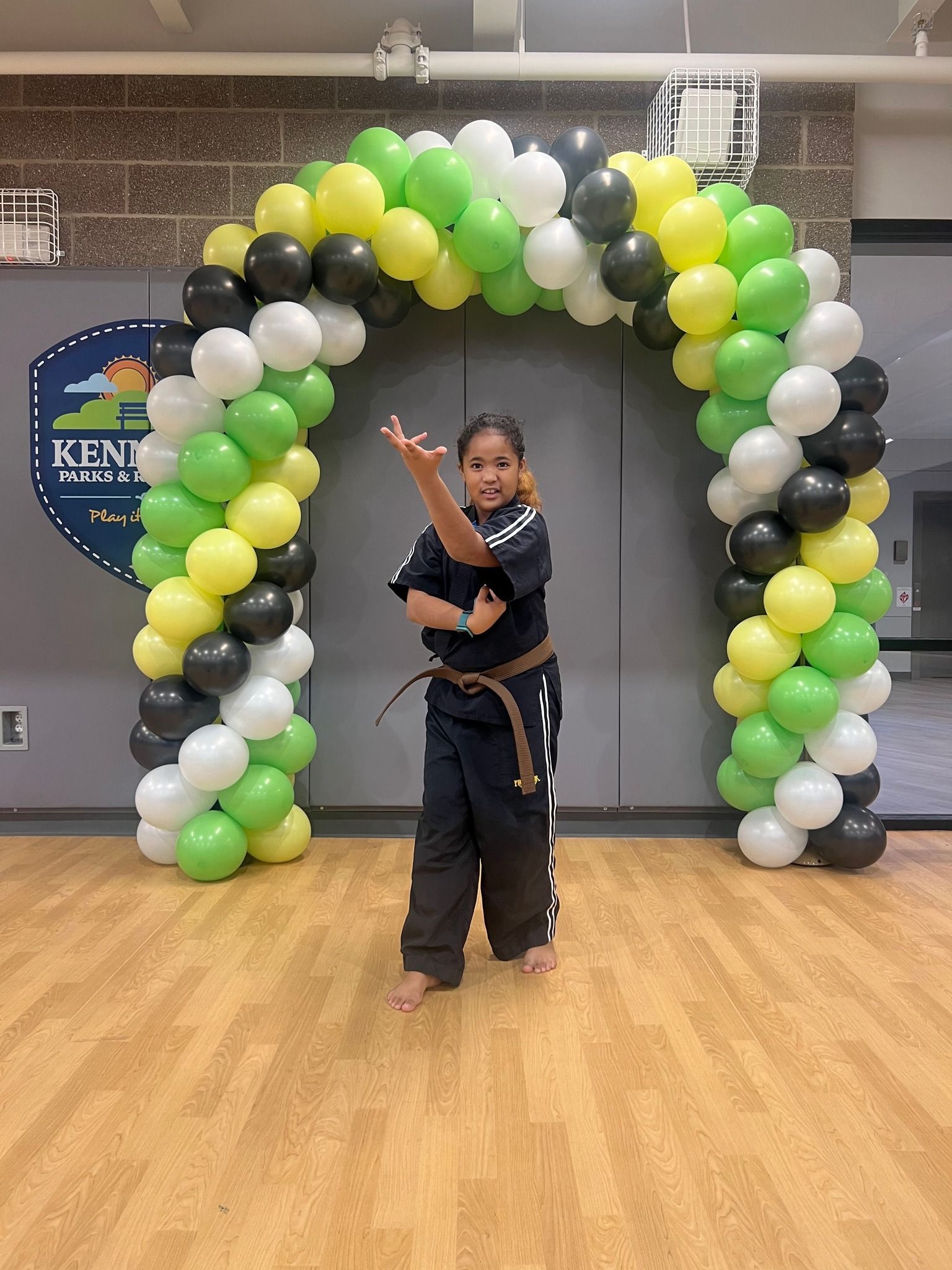 A person is holding a sparkler in their hand in the dark.