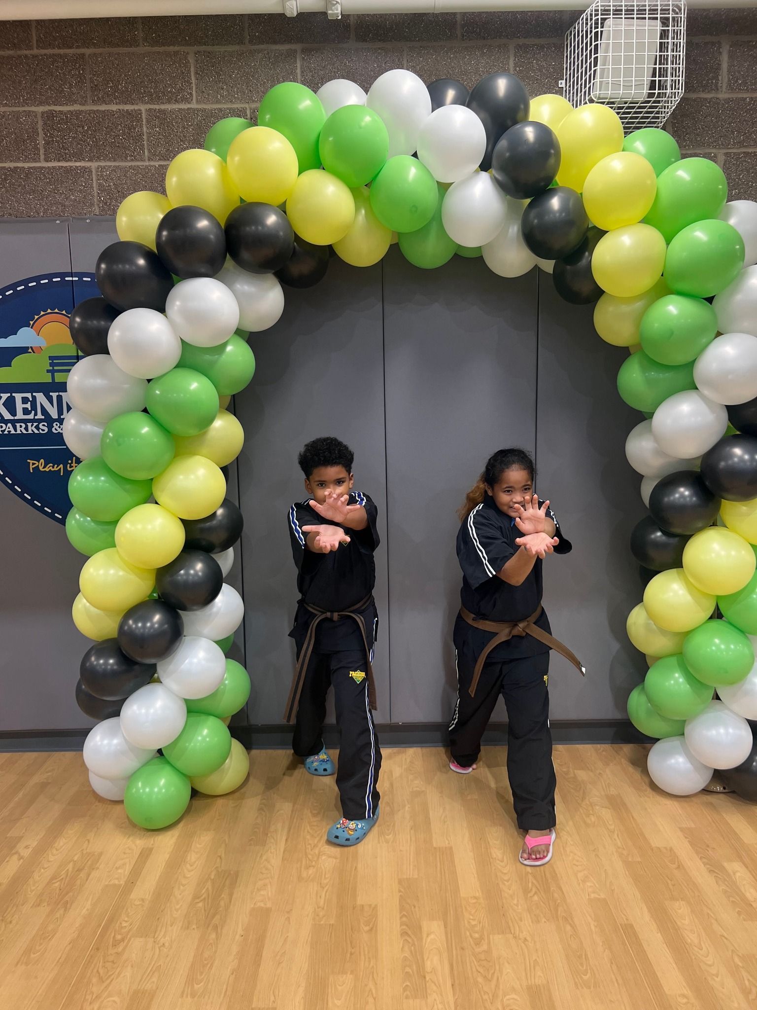 A person is holding a sparkler in their hand in the dark.