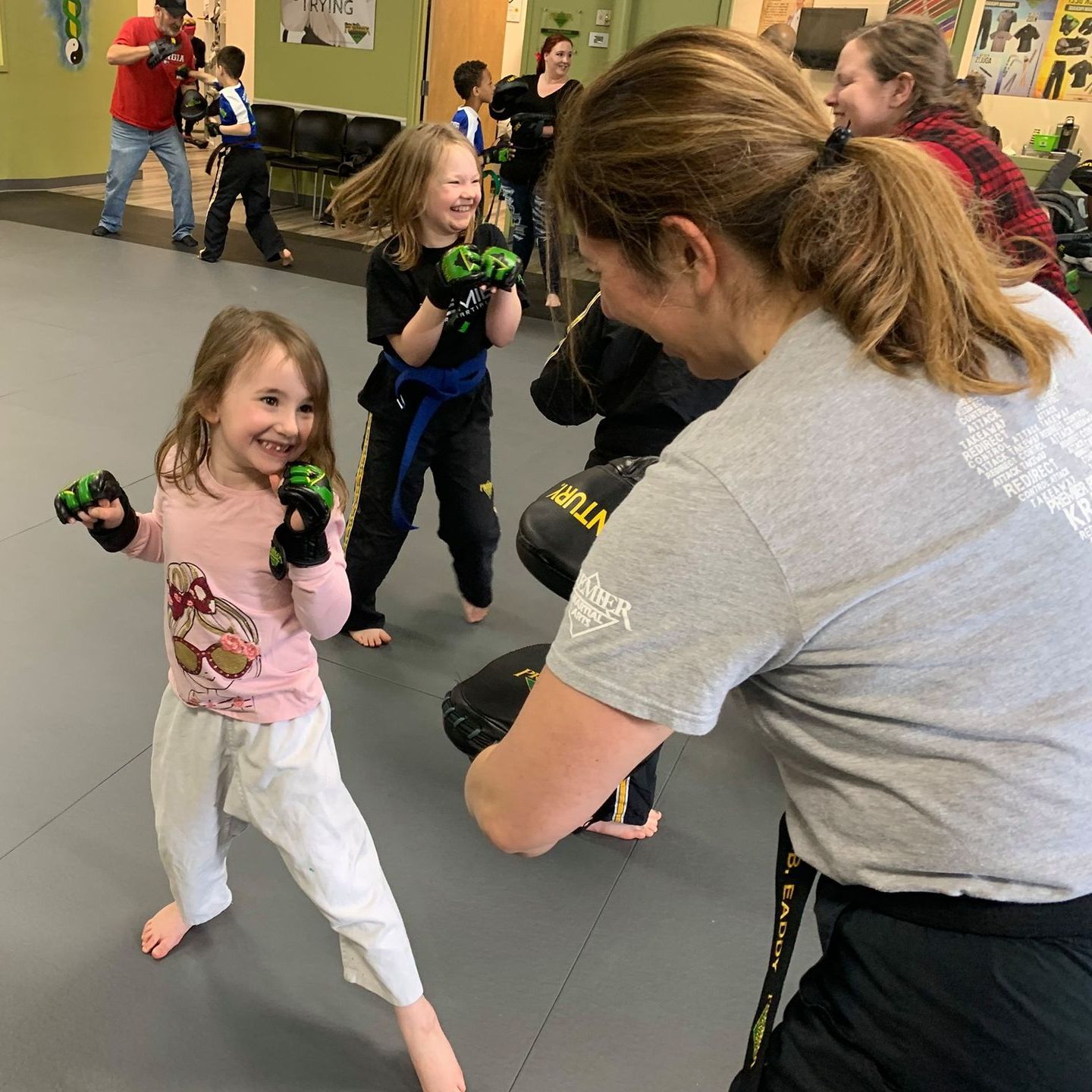 A boy and a girl are practicing taekwondo together.