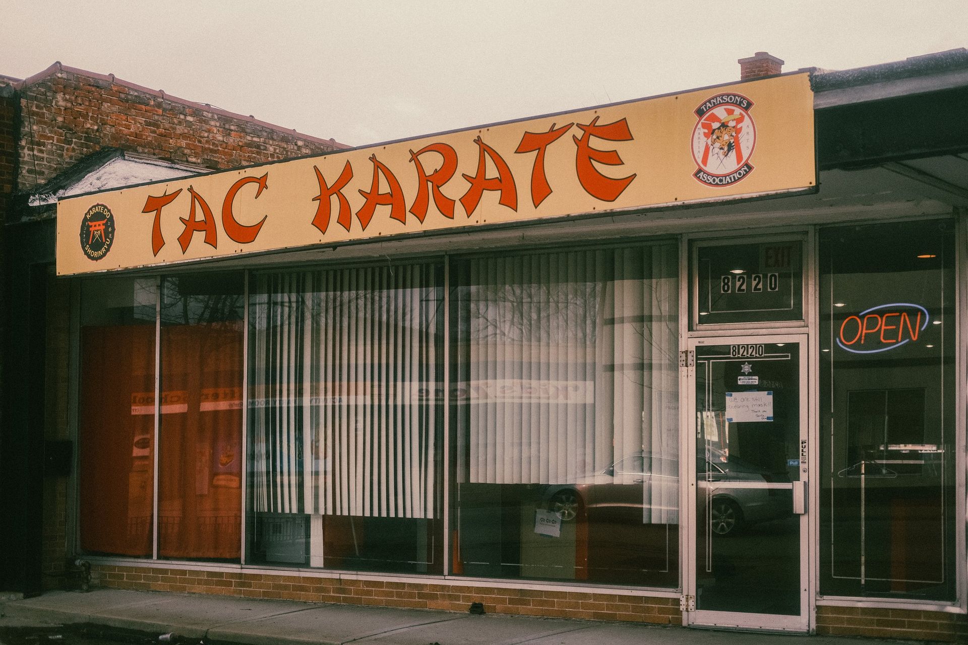 A building with a yellow sign that says tac karate