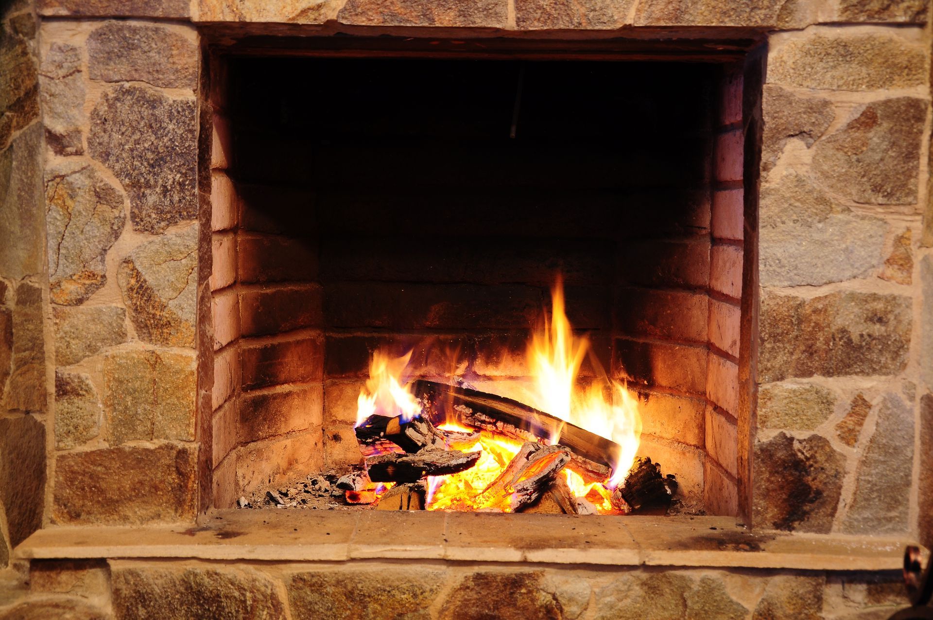 Fireplace with dry stones and flame