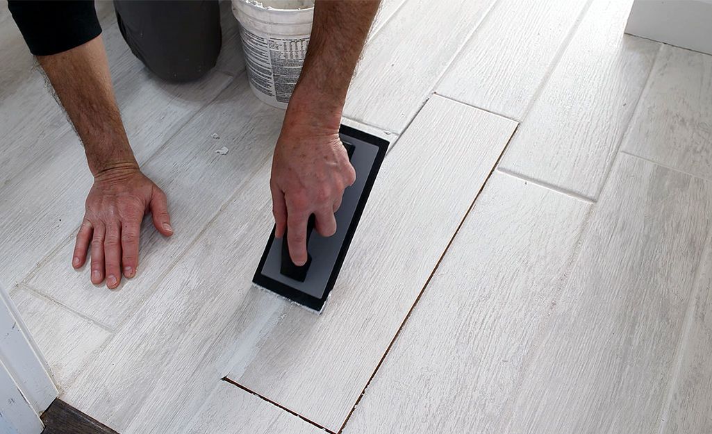 this is an image of a technician  fixing accent tile