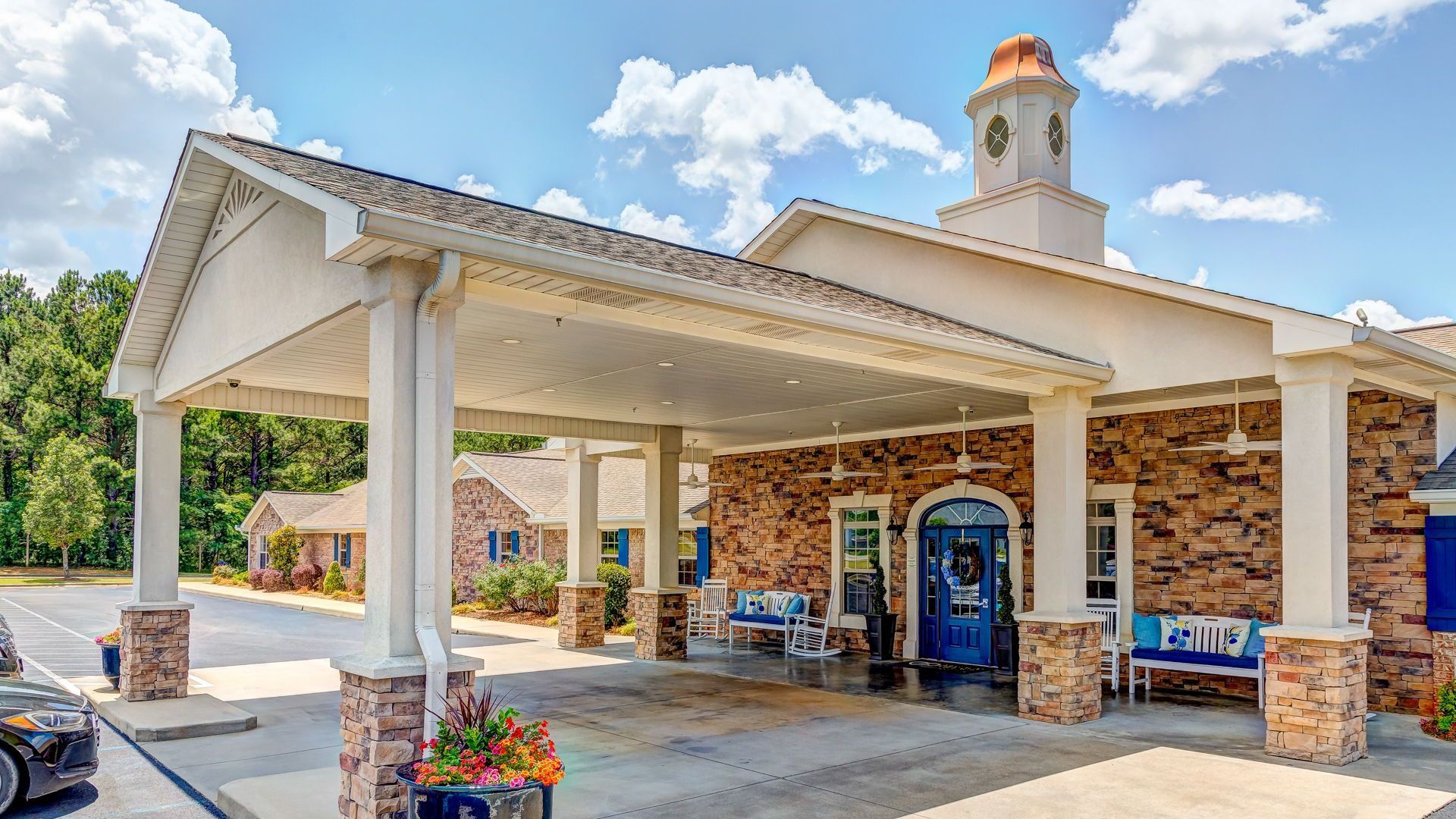 A large brick building with a car parked in front of it.