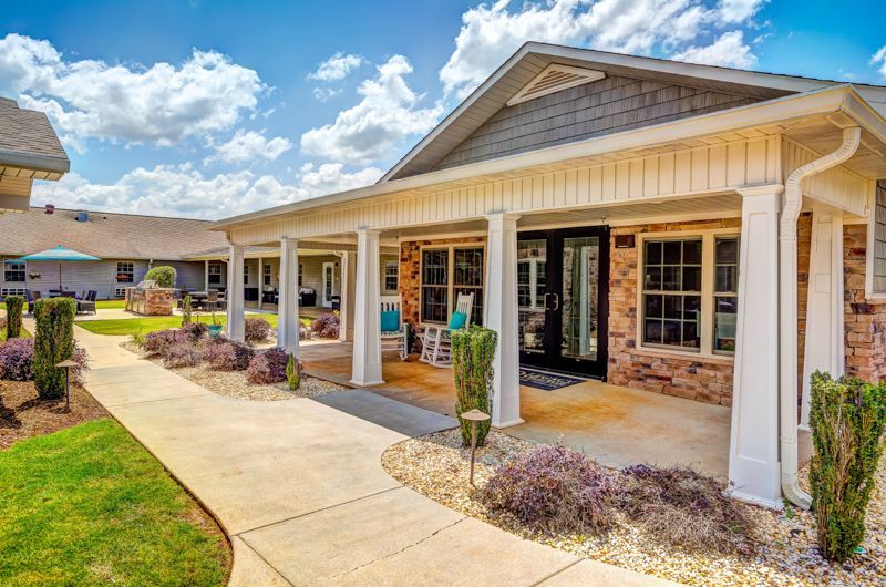 A large house with a porch and a walkway leading to it.