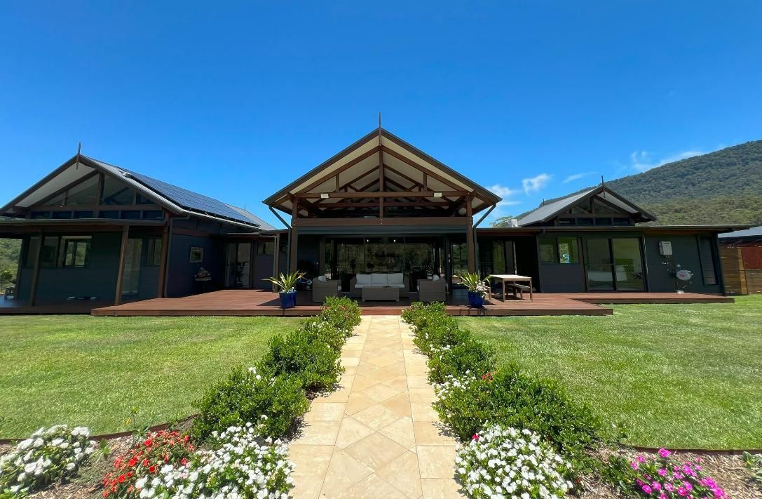 A Large House With A Lot Of Windows And A Walkway Leading To It — Datco Group In South Murwillumbah, NSW
