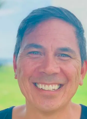 A close up of a man 's face smiling. David Howell life coach
