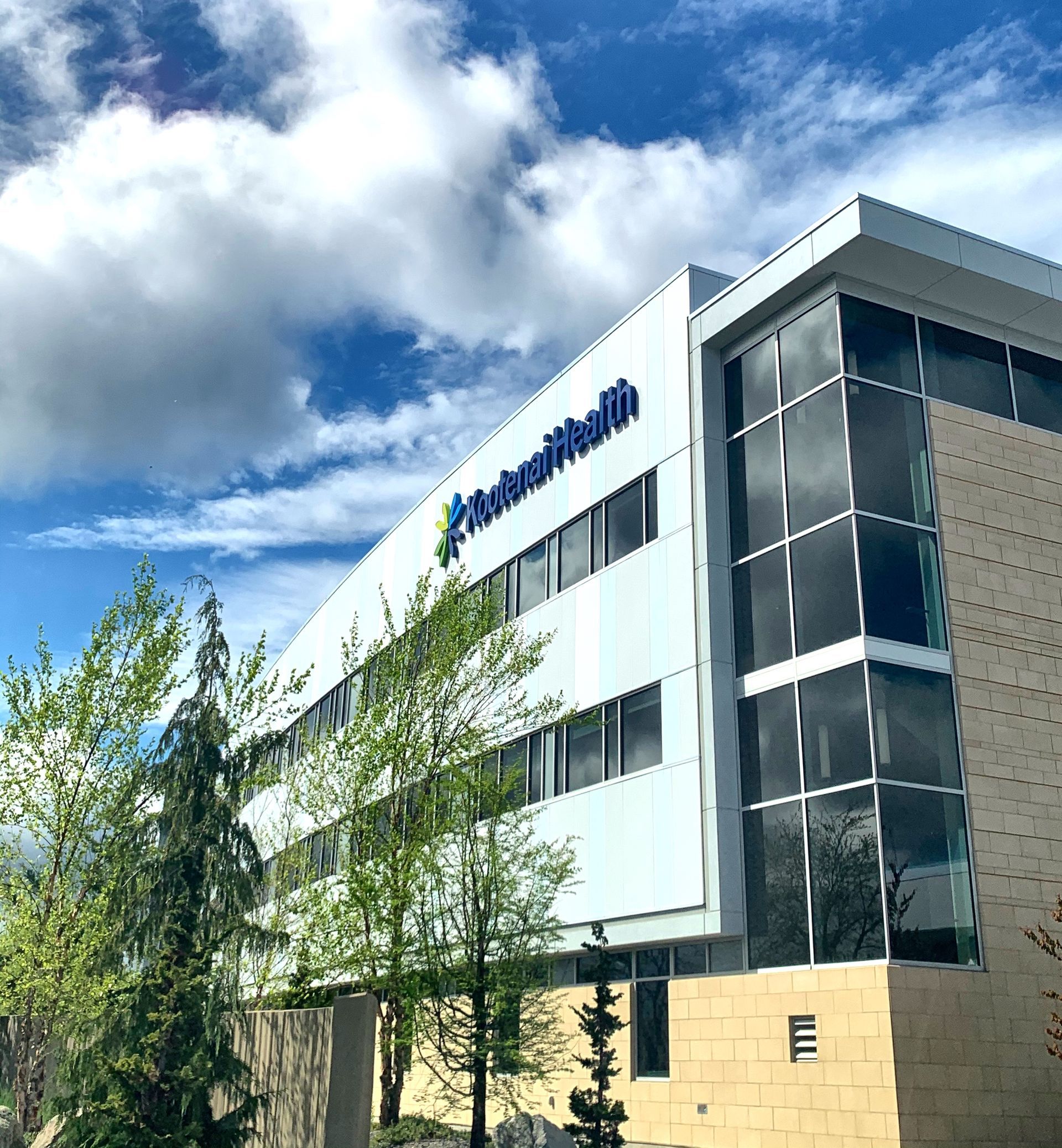 A large white building with a blue sign on the side that says network health