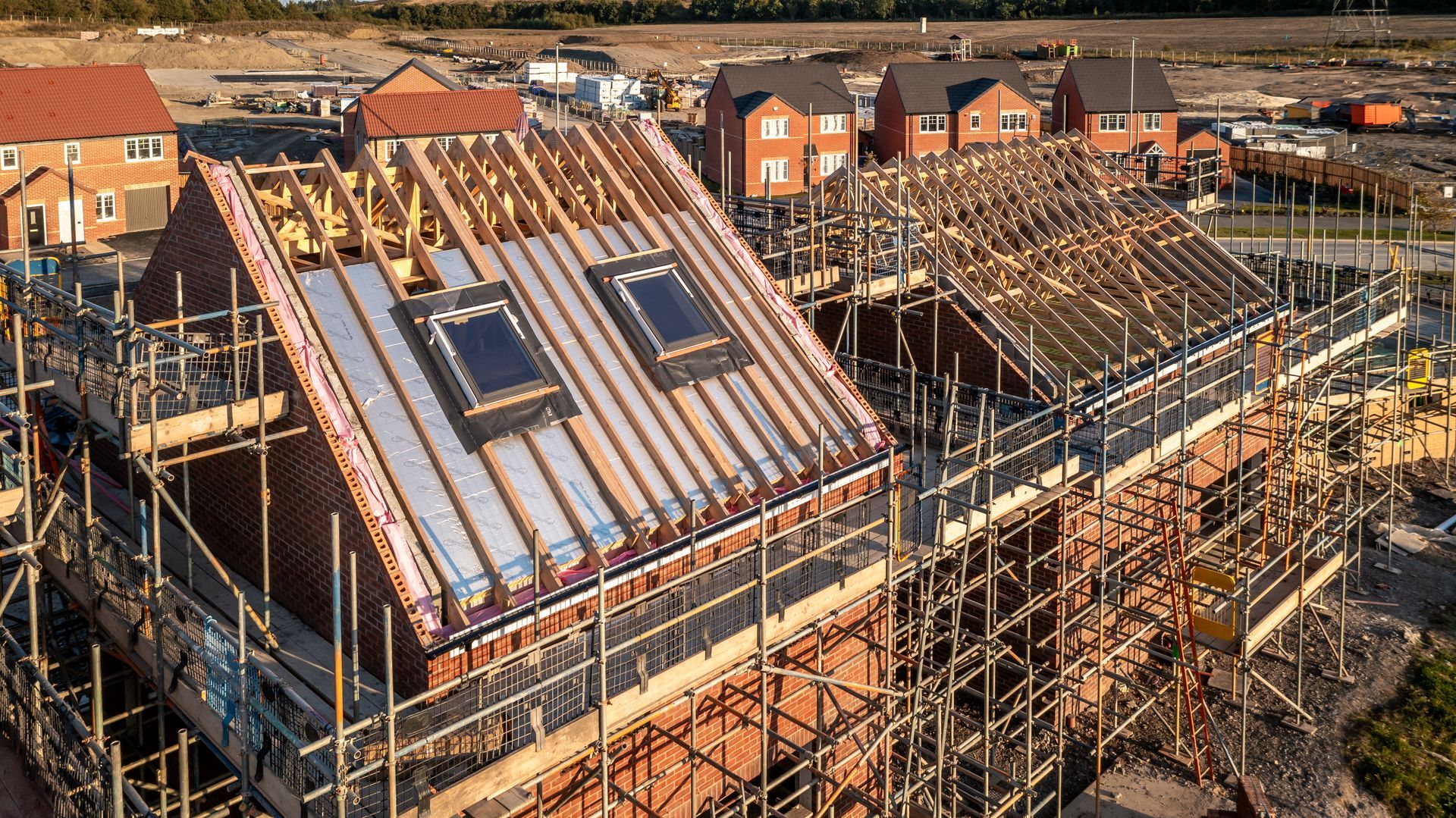 An aerial view of a house under construction with scaffolding around it.